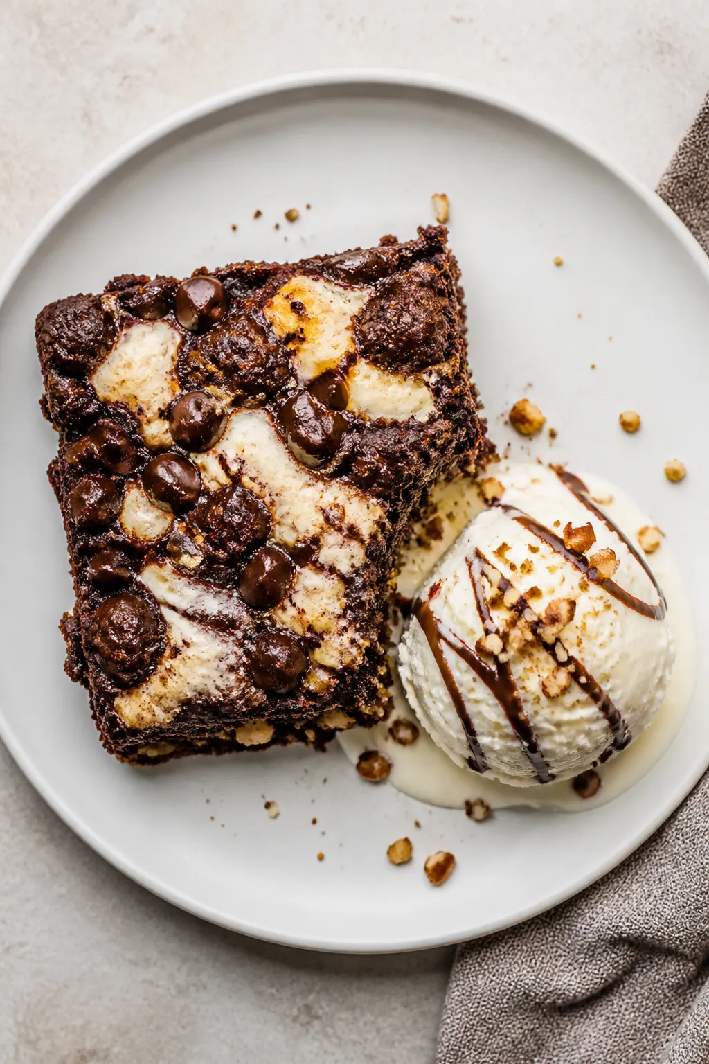 Final plated — Overhead shot of a warm square of Gooey Chocolate Earthquake Cake on a matte white