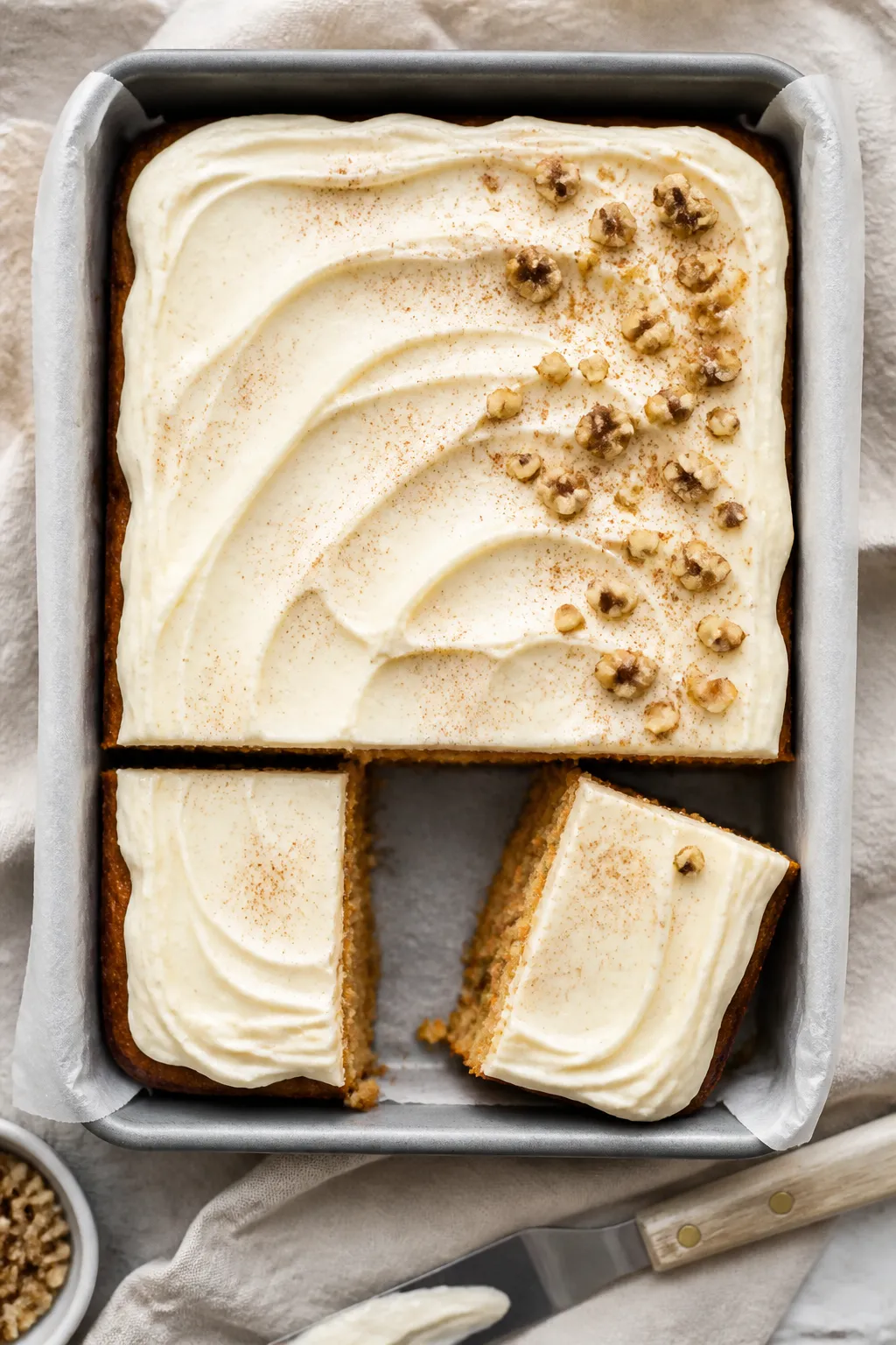 Overhead shot of a freshly frosted gluten free carrot sheet cake in a 9x13 pan, cream cheese frostin