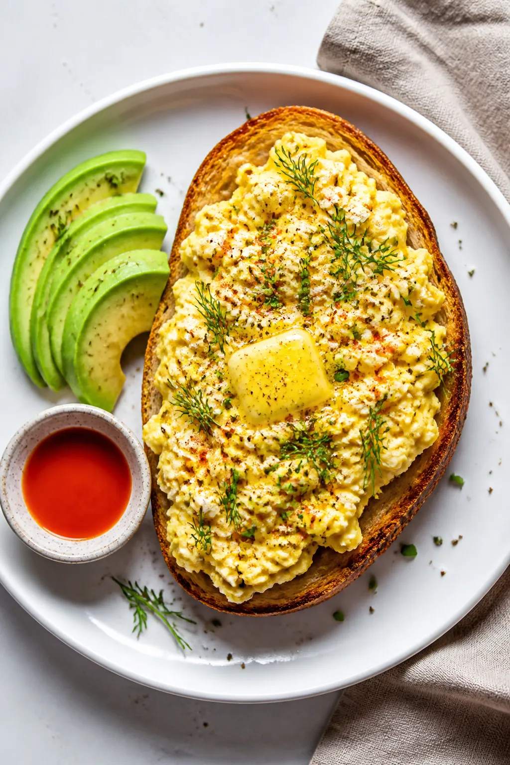 Final dish, tasty top view: Overhead shot of creamy eggs with cottage cheese, just-set and custardy,