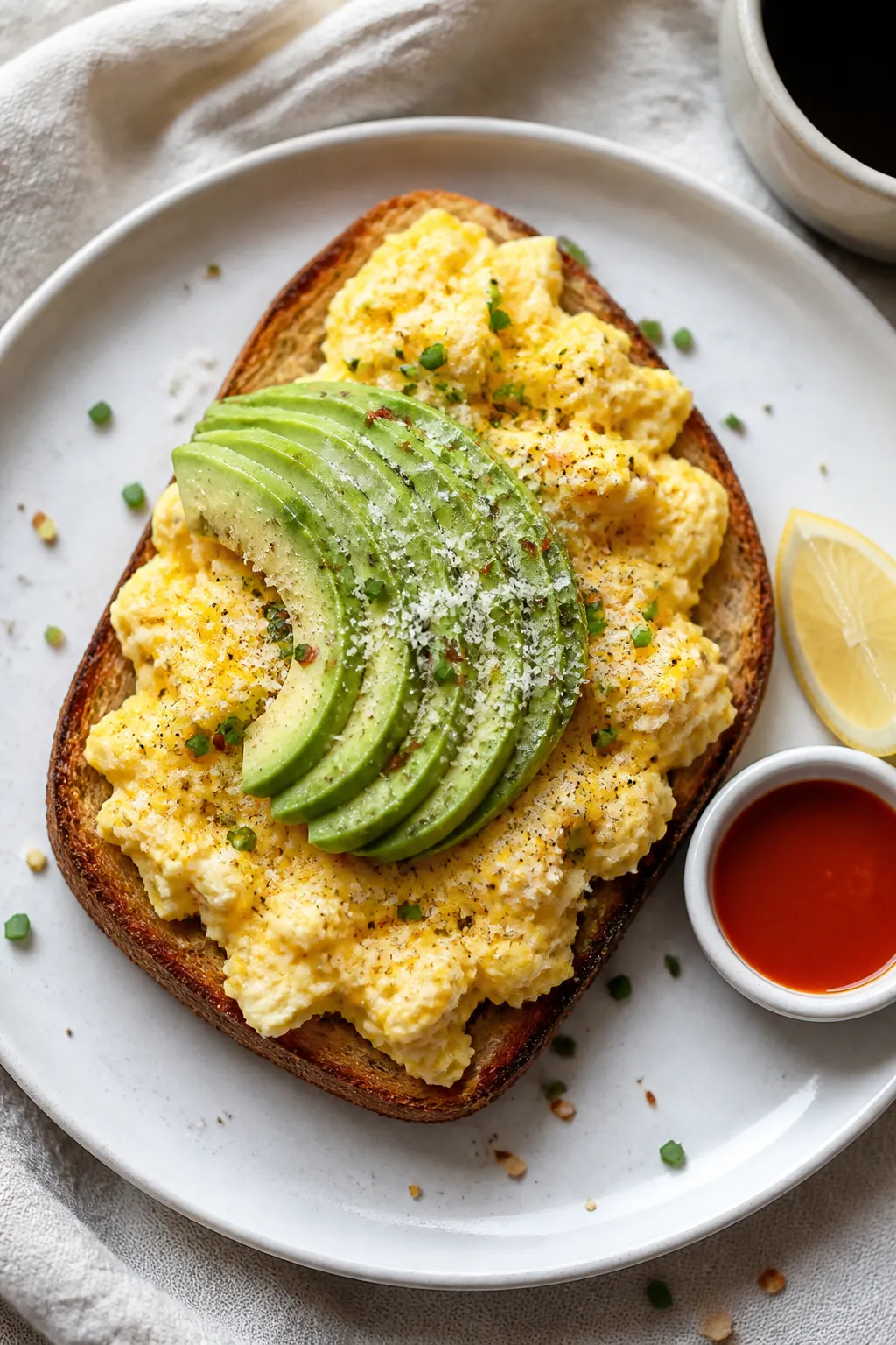 Final plated top-down: Overhead shot of cottage cheese eggs piled softly on golden-buttered sourdoug